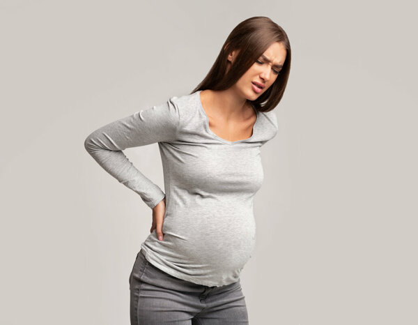 Боли в спине при беременности: отчего они возникают и что делать?